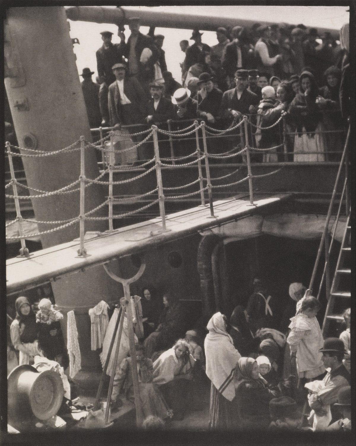 Alfred Stieglitz, The Steerage (1907) — passengers crowded on the lower and upper decks of a ship, separated by a gangway, in stark black and white